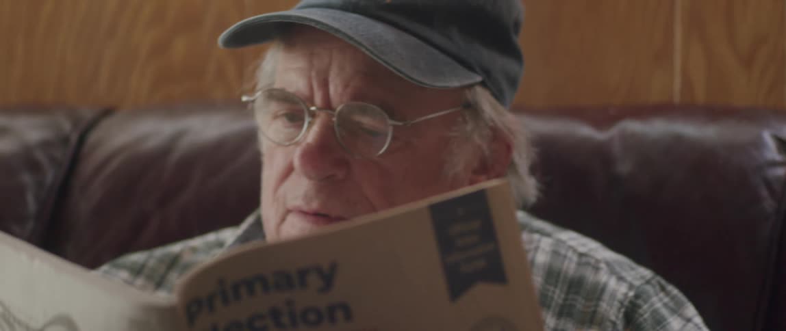 Portrait of an elderly man with prescription glasses sitting reading better