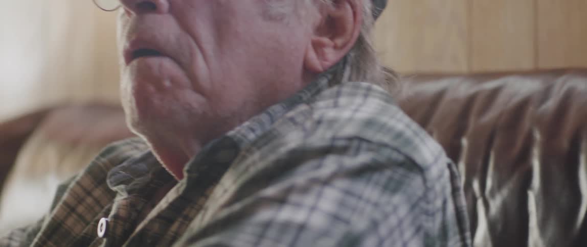 Portrait of an elderly man reading and having a facial expression of curiosity