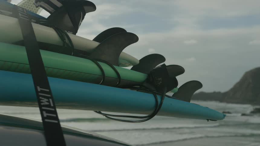 Surfboards are stacked on the car