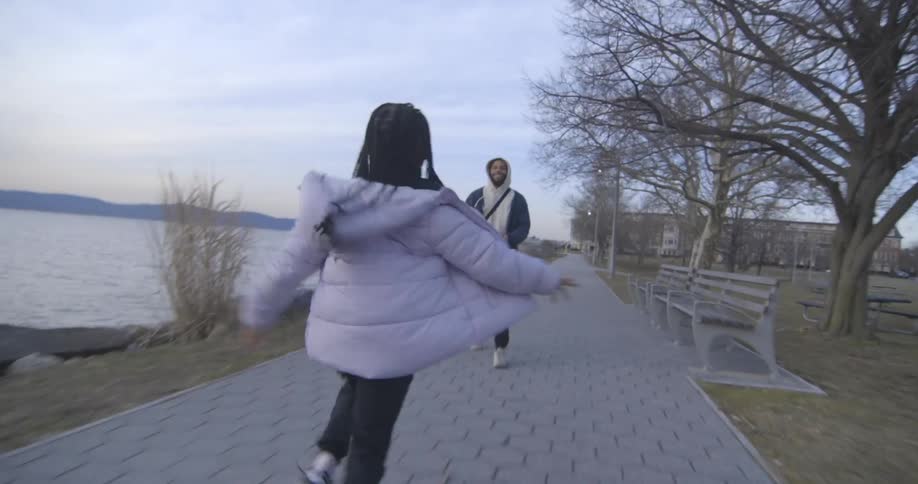 A girl runs into her fathers arms