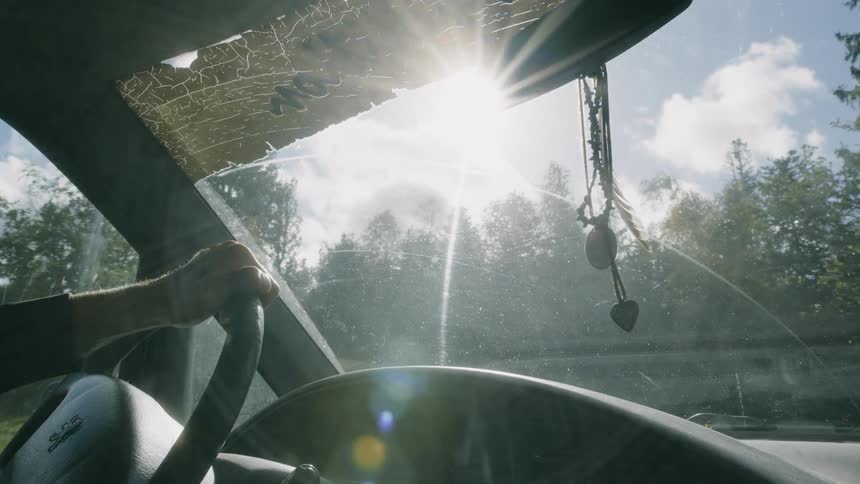 Man drives vehicle over rough terrain on a sunny day