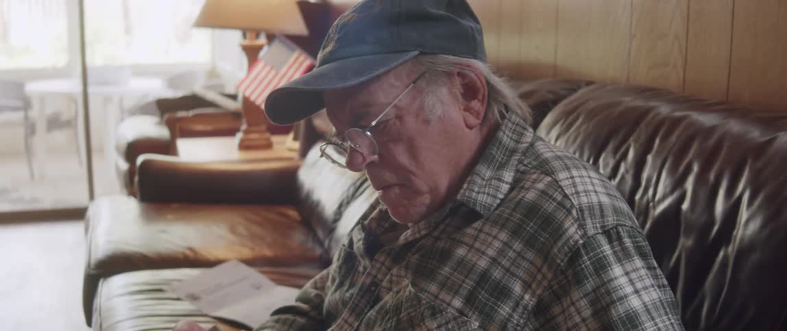 A man is reading a magazine at home