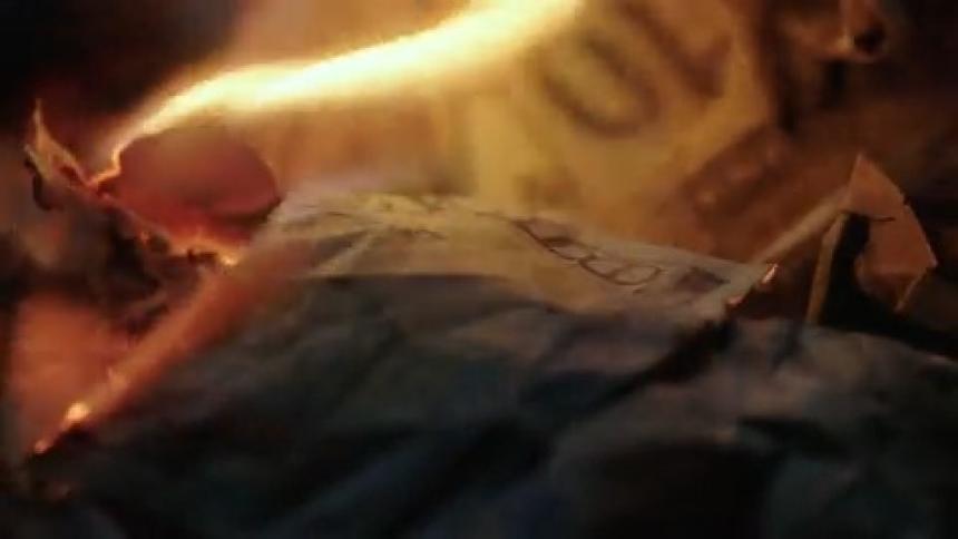 Fire burning money bills