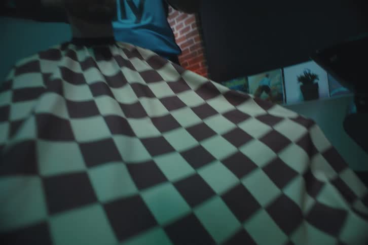 A man is getting a haircut in a barbershop