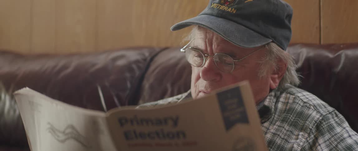 Man reading while sitting on the couch on a sunny day