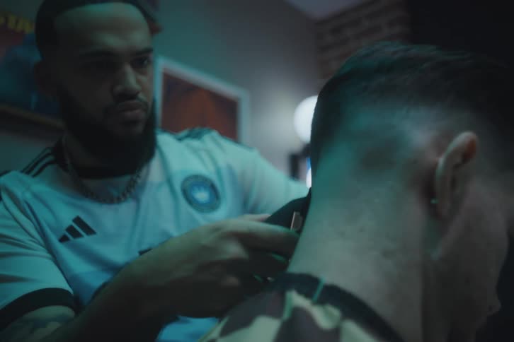 Barber giving his client a haircut