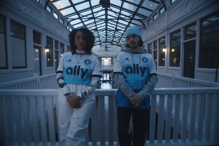 A young couple modeling matching outfits