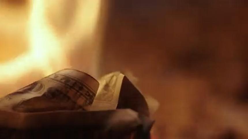 Extreme close up of a burning banknote