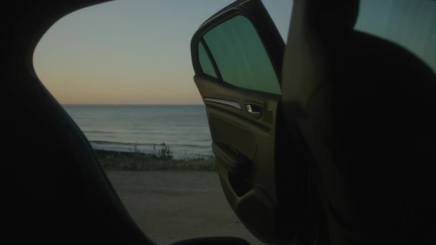 The car door is open leading to the beach