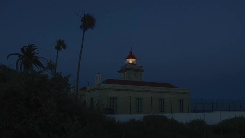 House with gazebo with a flashing light at night