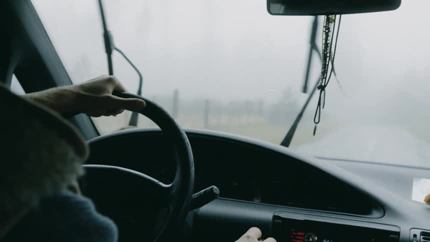 Man drives along highway on a stormy day