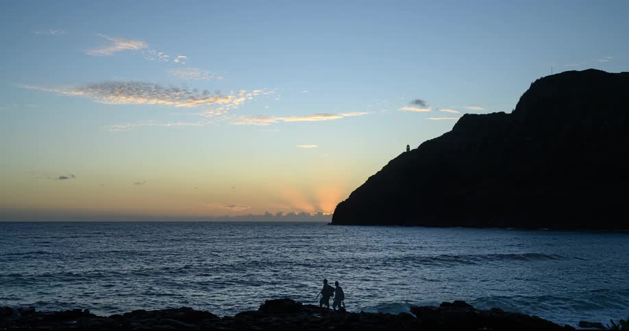 Sunrise on a beach with some waves breaking on the shore on a sunny morning