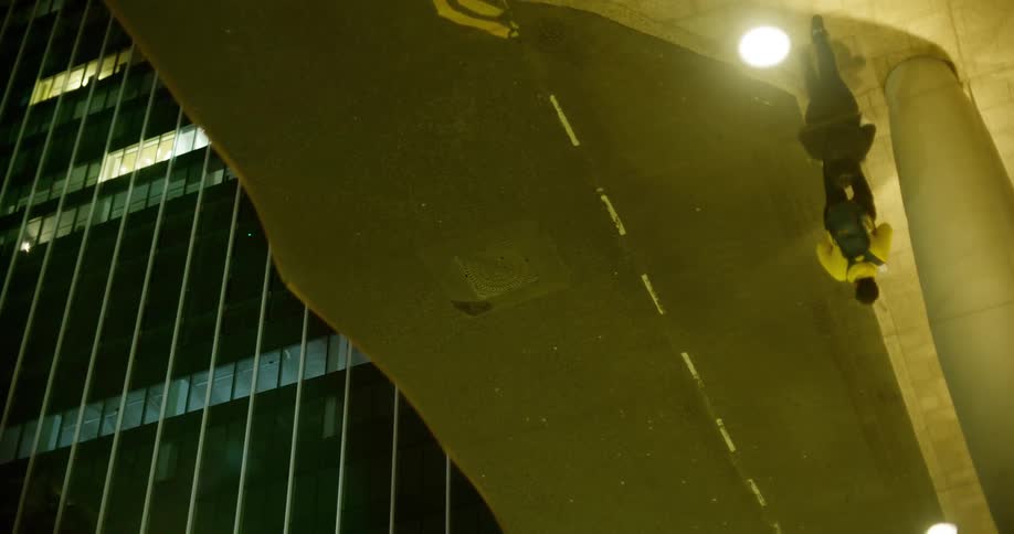 Distorted reflection of two people walking through a city at night