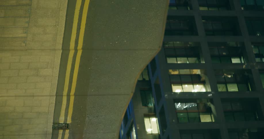 Reflection of two bicyclists and a car in a city