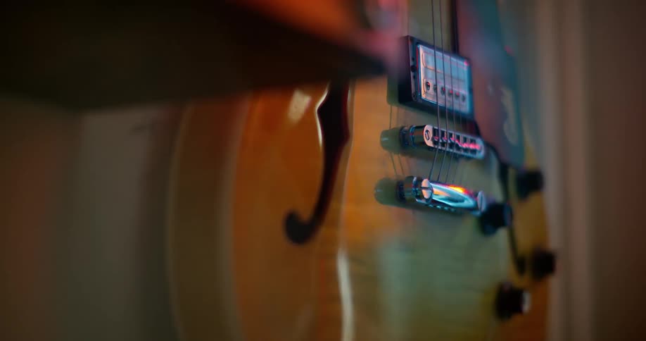 An electric guitar hanging on a wall
