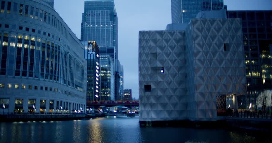 Wide shot of a cityscape with water in the foreground