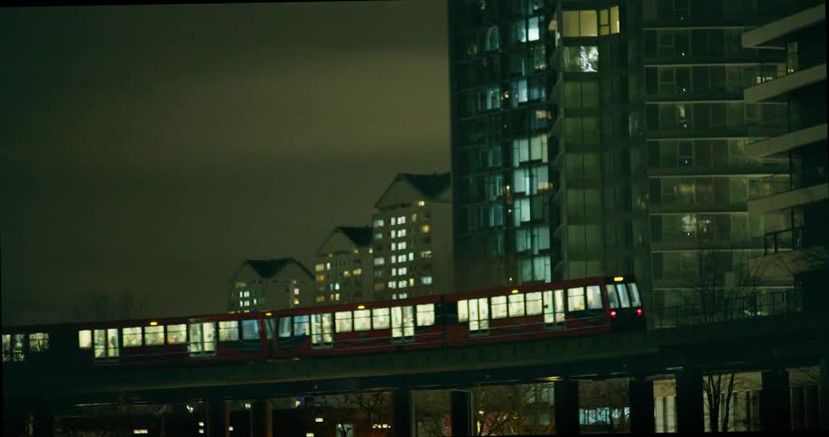 A train trundles past city high rise buildings