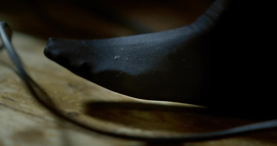 Close up of a black stockinged foot tapping to a beat