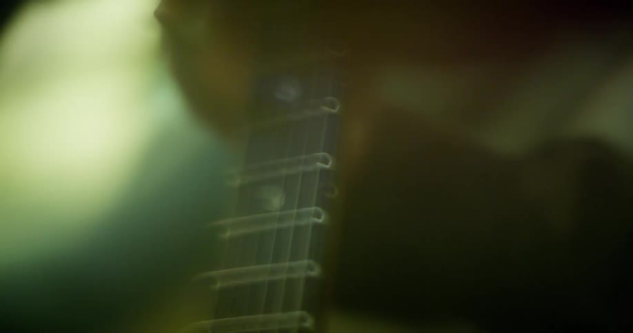 Distorted close up of fingers on a guitar fretboard