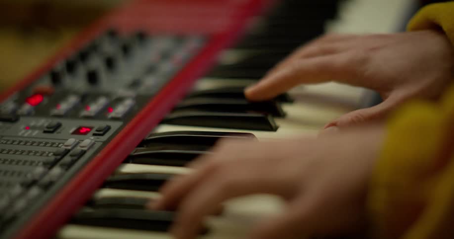 Hands of a person playing an electronic piano