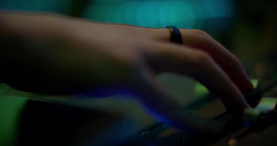 Womans hand adjusting a music mixer