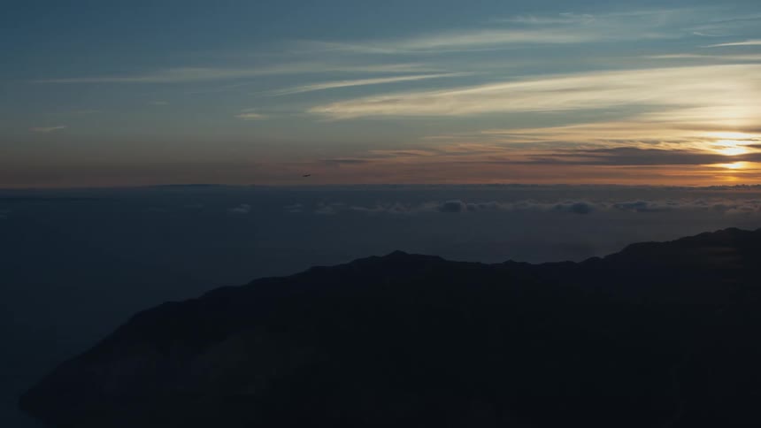 A large island highlighted with a large ocean being illuminated by a strong beam of sunlight