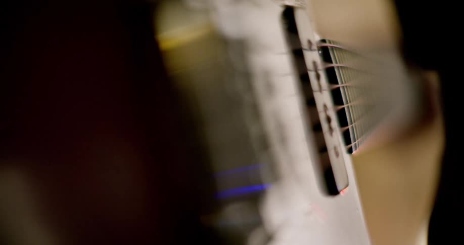 A person strums a guitar