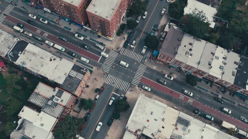 Aerial view of an urban city with intersections and vehicle traffic during the day
