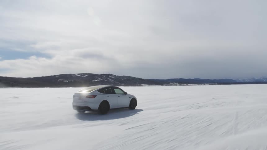 A car driving on a plain covered in ice and snow