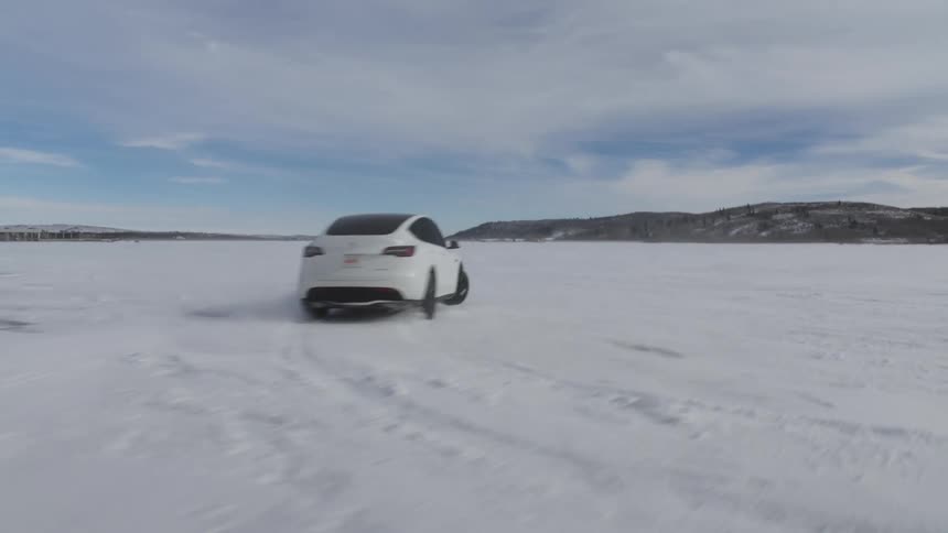 A car drifting and turning around on a plain covered in ice and snow