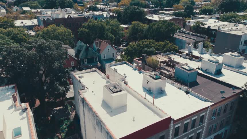 Aerial panorama of an urban city with commercial and residential buildings with intersections and trees around