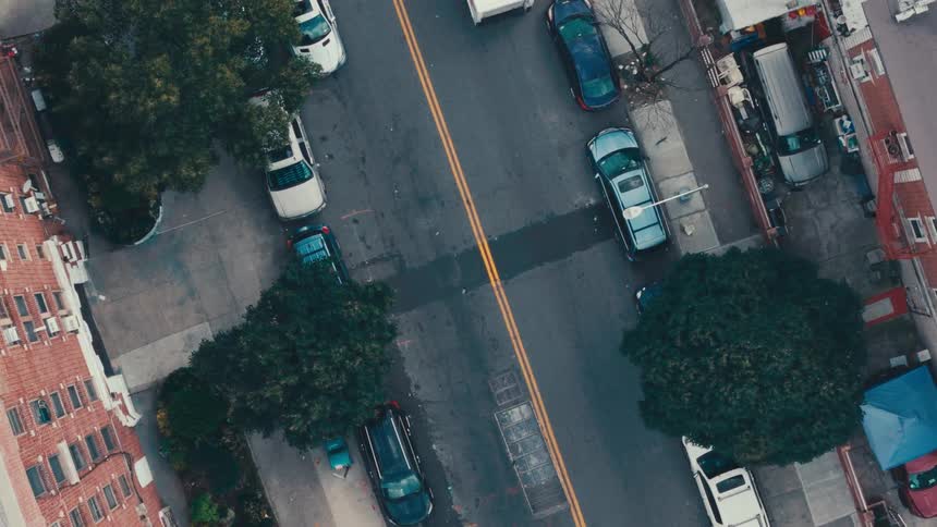 Cars parked and driving on a residential neighborhood road