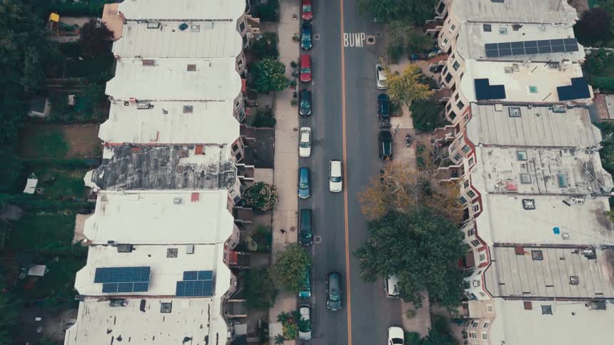 Aerial panorama of the roofs of residential buildings in a city and with intersections and vehicle traffic