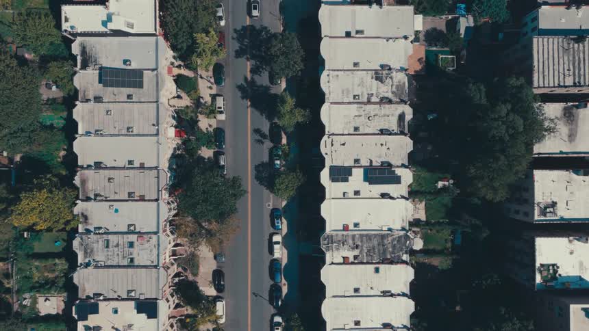 Aerial panorama of residential buildings in urban areas with vehicles in daylight