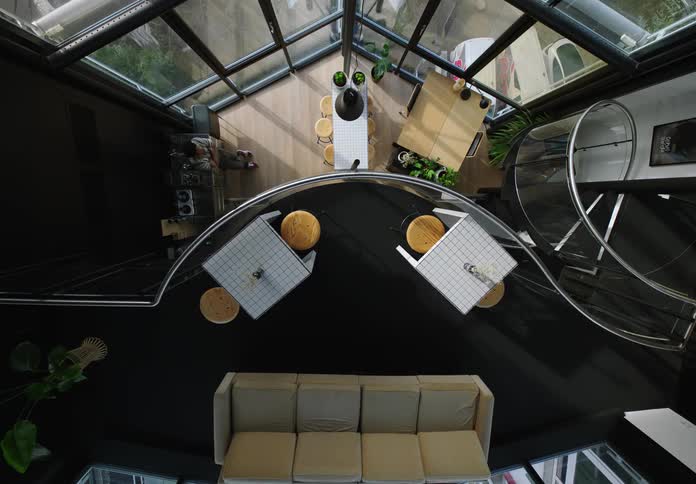 Some workers are in the kitchen of an office in a mirrored building