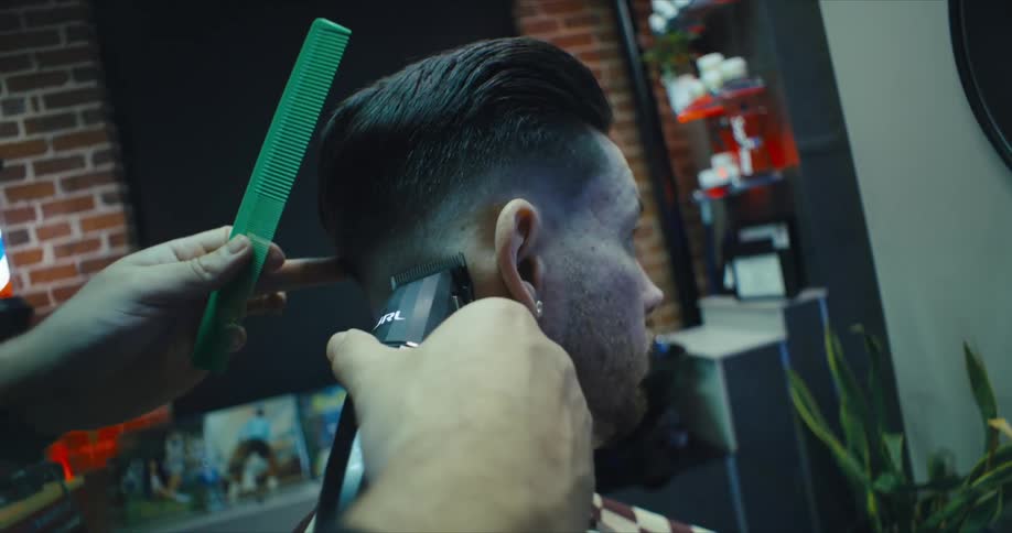 A barbers had carrying an electric shaver to cut a clients hair
