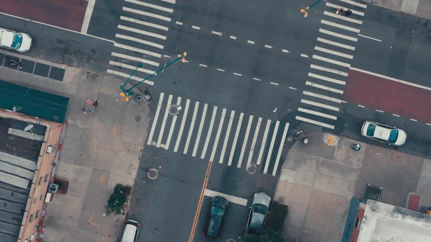 An aerial view of an intersection of several streets with crosswalks