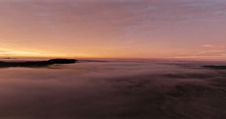 An aerial view of a sunset over clouds
