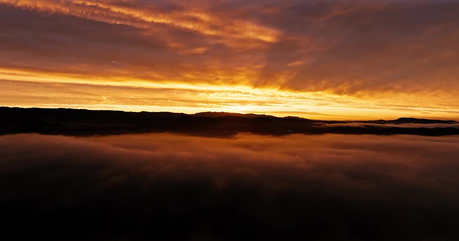 Aerial scenery of a sunrise landscape on the orange horizon