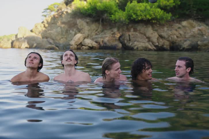 A group of friends in the water looking and laughing