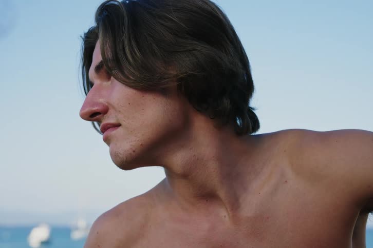 Portrait of a young man without a shirt in the natural environment on a cloudless sky day