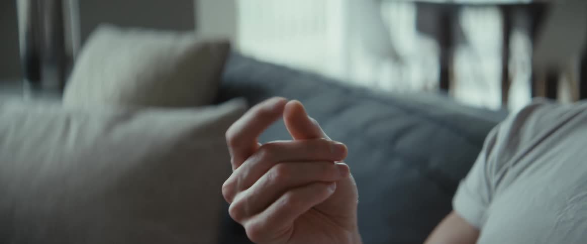 A person is sitting and is closing and opening his fingers on his hand