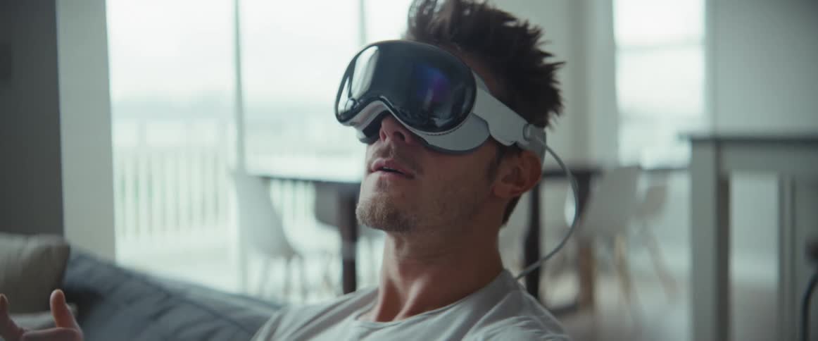 Man sitting in the room using virtual reality glasses