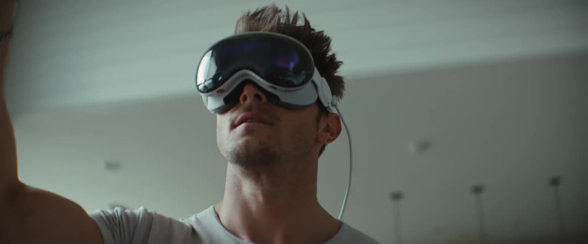 Portrait of a man walking around the house and moving his hand while wearing virtual reality glasses