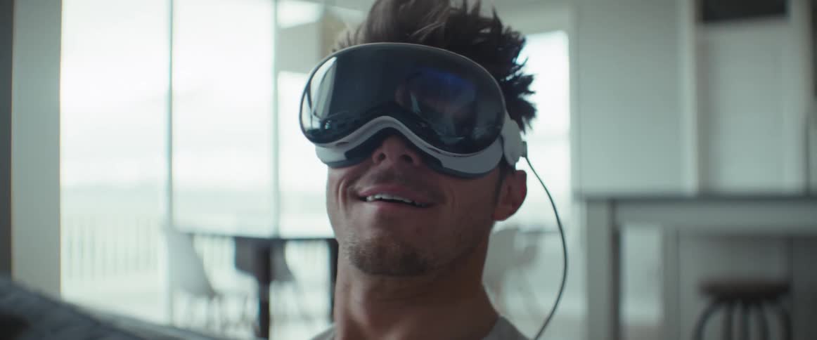 Portrait of a man sitting having fun while using a virtual reality glasses