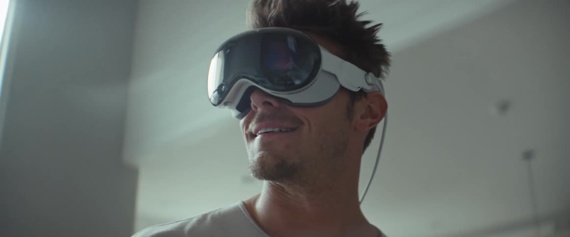 Portrait of a smiling man walking around the house wearing virtual reality glasses