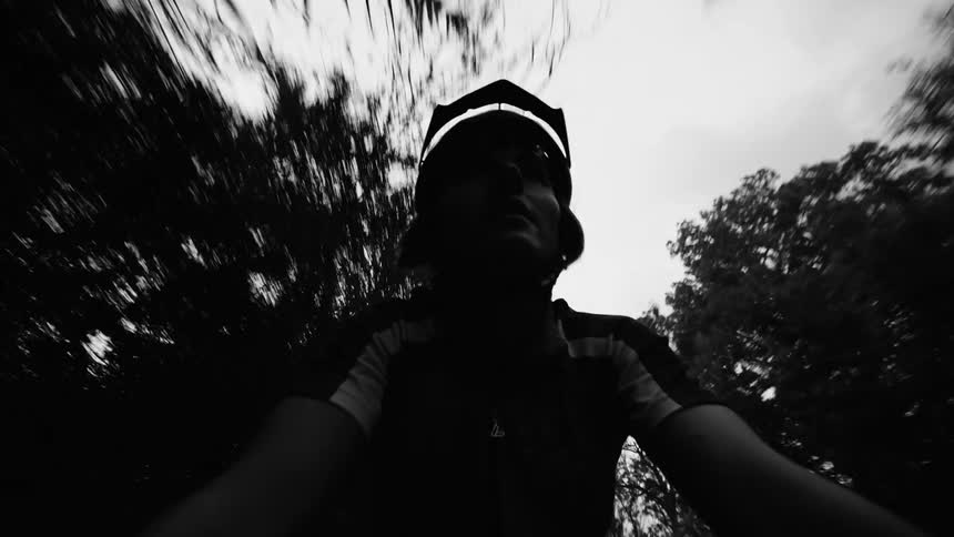 Young is man cycling down a road