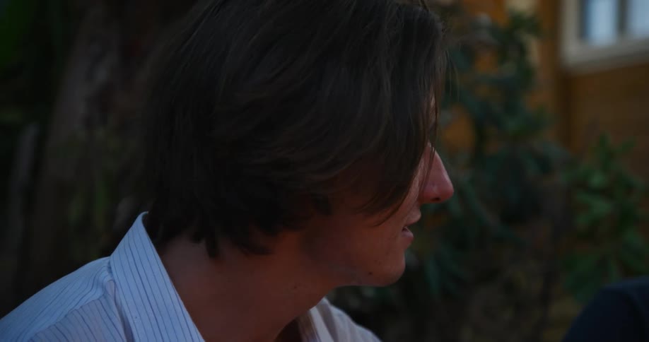 Young looks around thinking he talks to someone the camera moves to show another person in the background