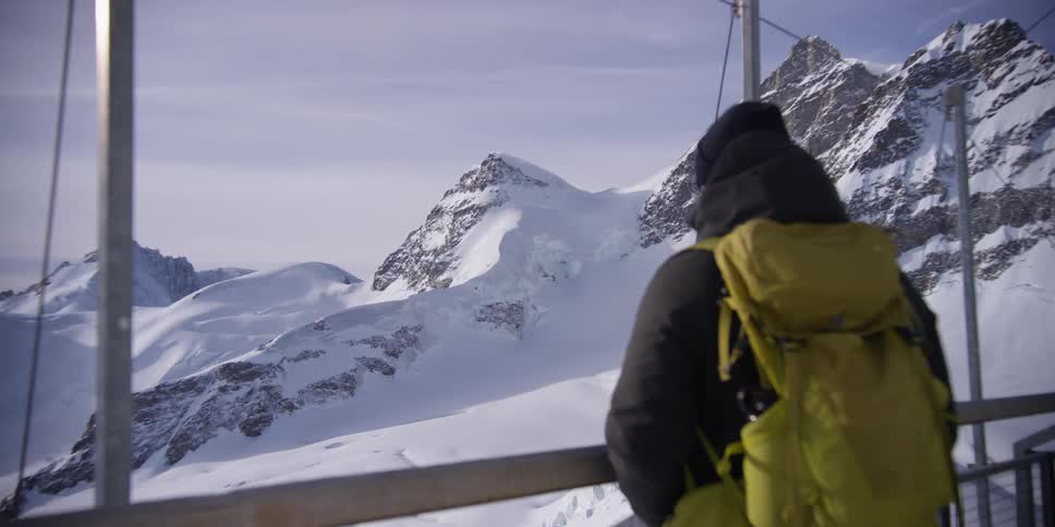 A man is viewing the mountain range