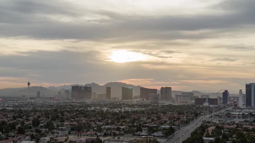 Aerial panorama of a metropolis with skyscrapers and mountain ranges on the horizon in a morning